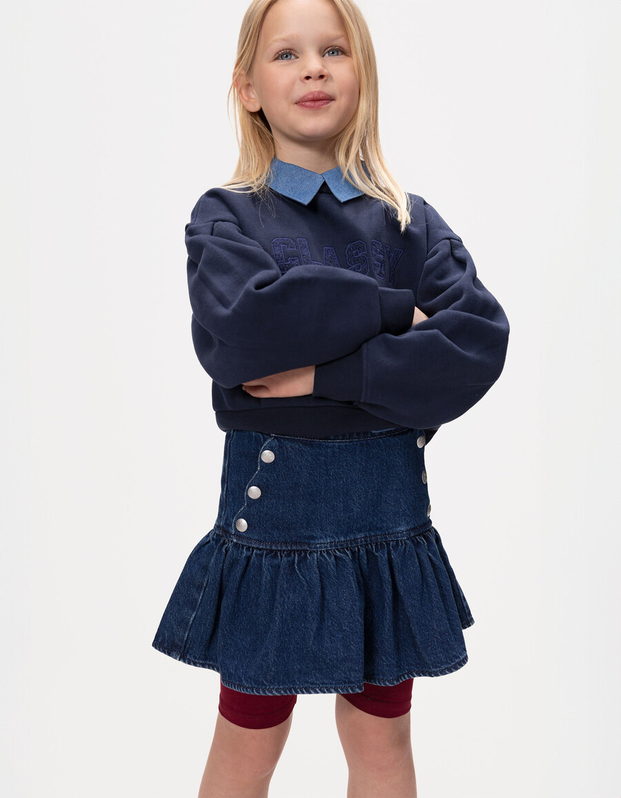falda vaquera azul para niña con botones a presión estilo caída frontal
