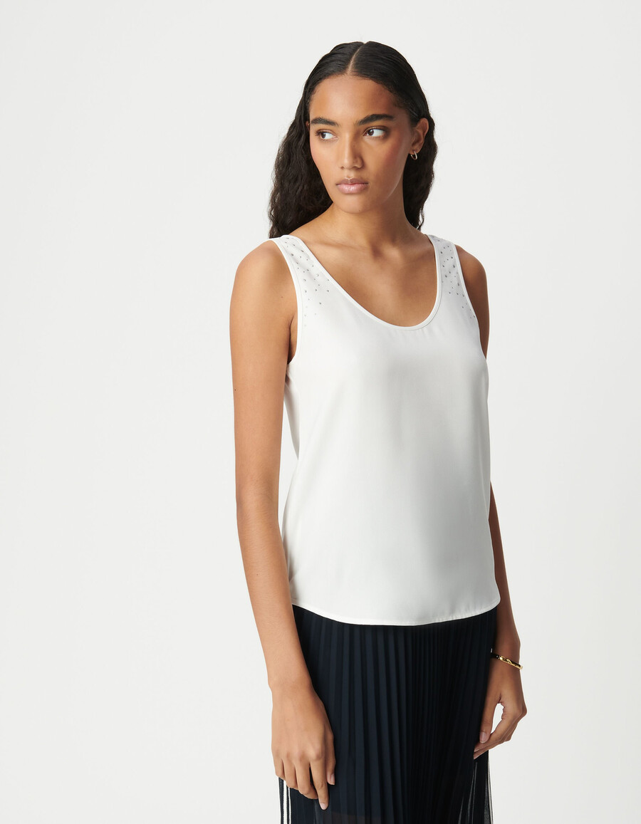 camiseta blanca reversible sin mangas para mujer con tachuelas