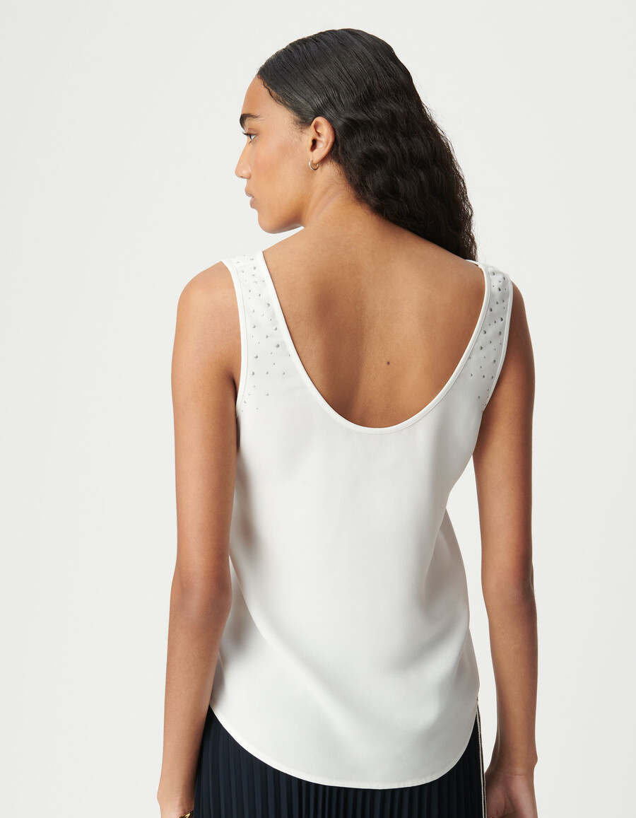 camiseta blanca reversible sin mangas para mujer con tachuelas