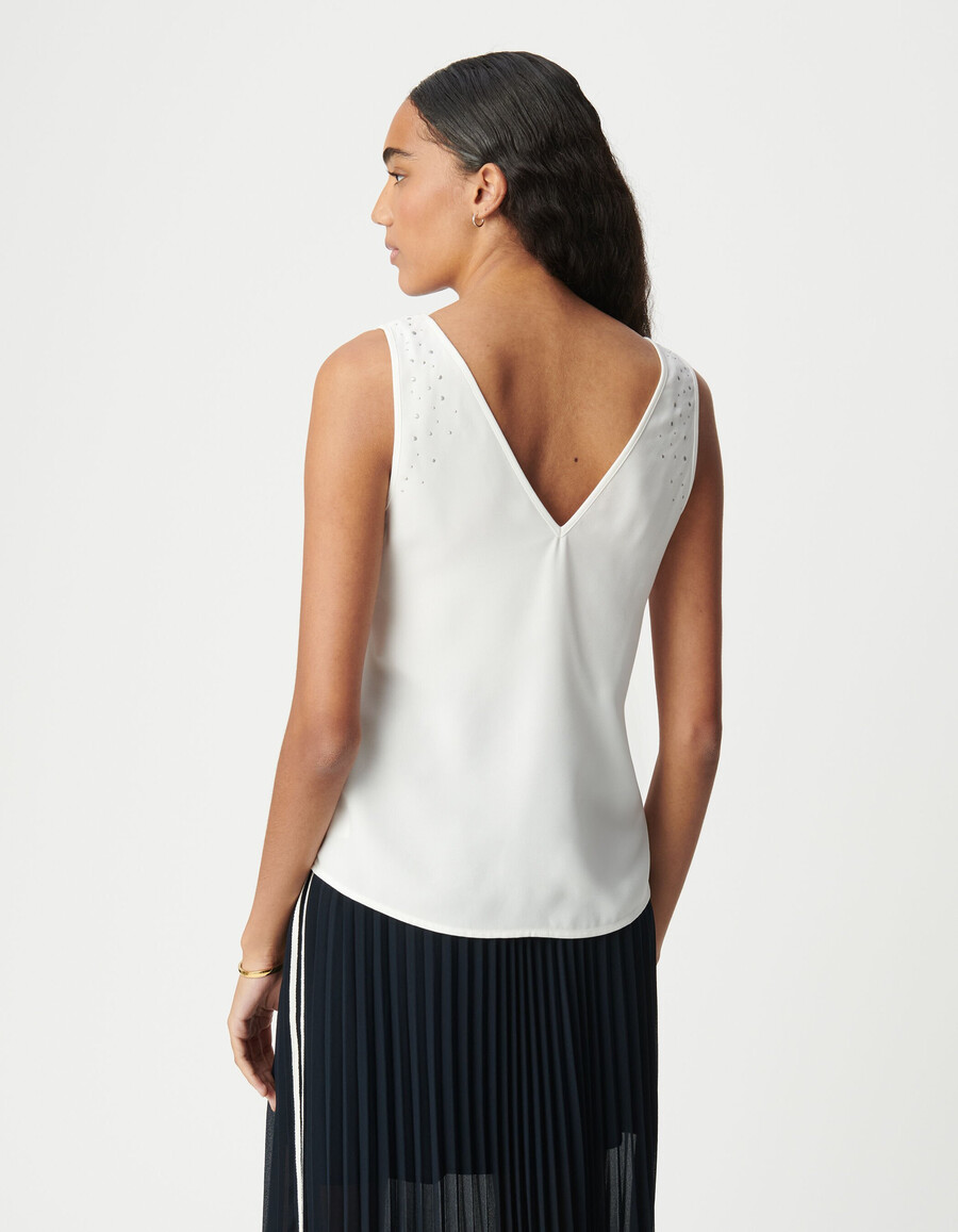 camiseta blanca reversible sin mangas para mujer con tachuelas